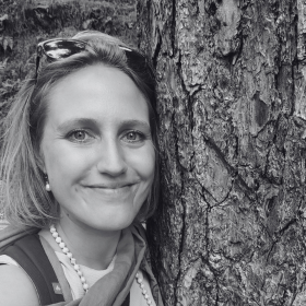 meditation teacher smiling with tree