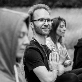male yogi praying and smiling