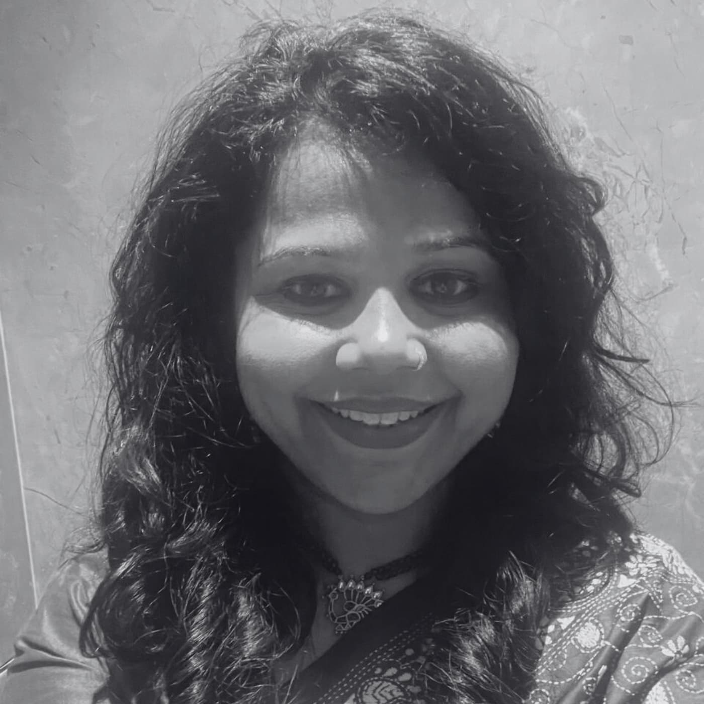 Smiling woman with brown hair in black and white